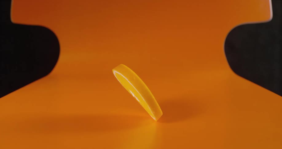 Orange slice spinning over an orange plastic chair
