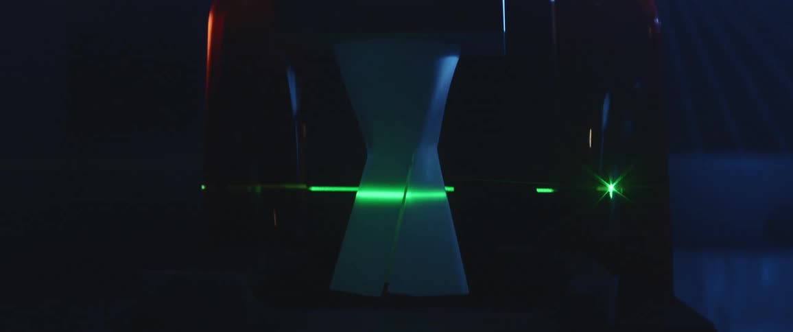 A 3d printer in a room with a green laser