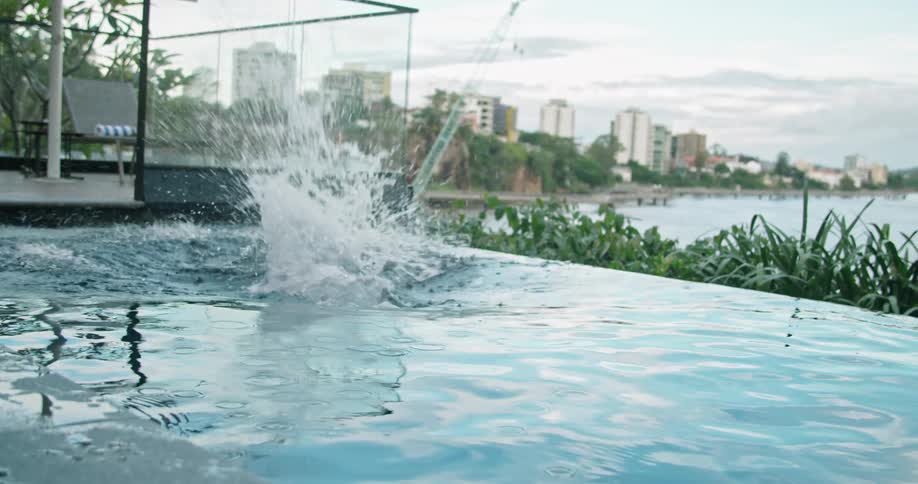 A man dives in to a hotel swimming pool