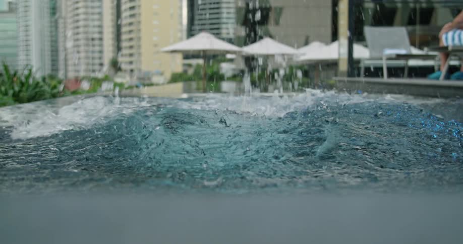 A man dives in to a swimming pool