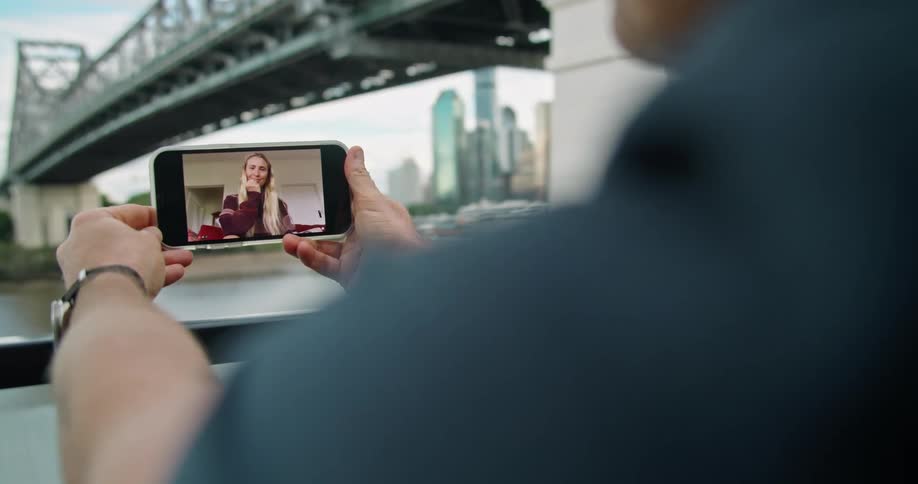 Man talking with a woman on a video call on his phone
