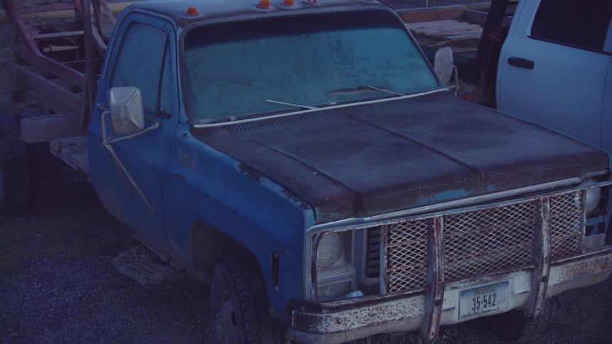 A beat up old ranch truck covered in morning ice in rural montana before a hard days work begins