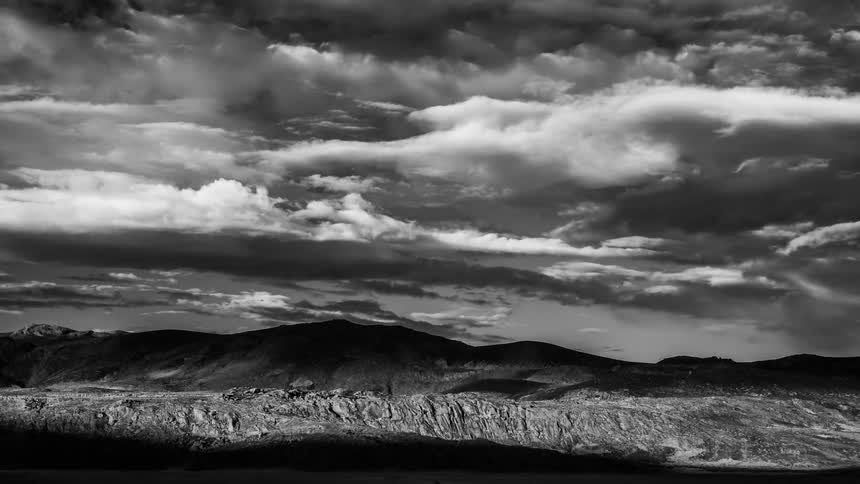 Time lapse of clouds passing over large rock formations