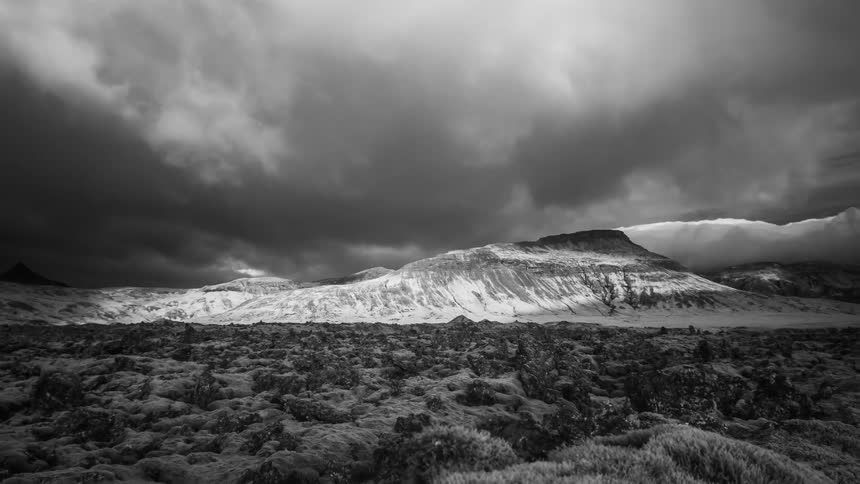 A time lapse of clouds over a mountain