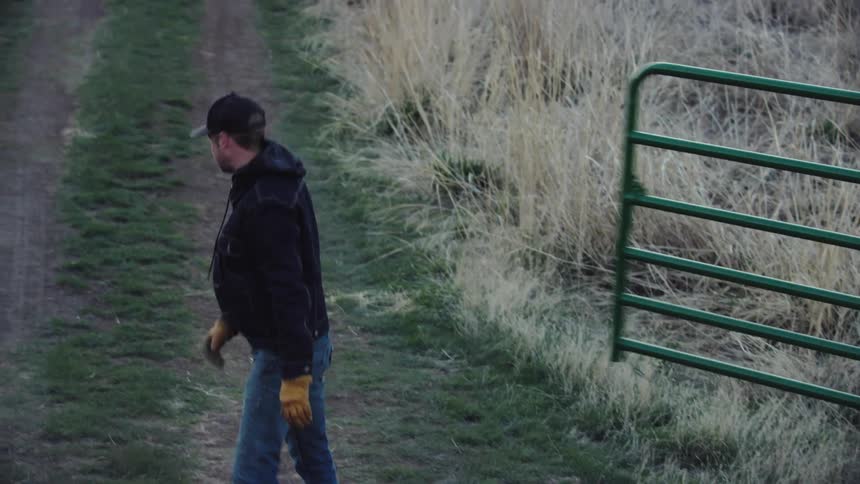 Early morning shot of a rancher opening for business on his rural bison ranch deep in Montana