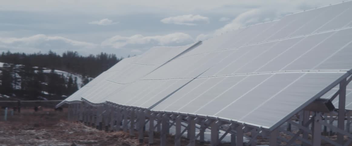 Solar panels under a cloudy sky