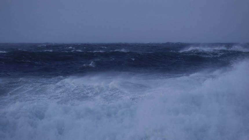 Winds blowing on the ocean waters with waves with the sky and clouds in the background