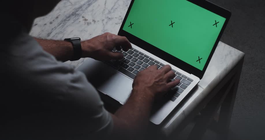 Man typing on the keyboard of a laptop with a replaceable screen