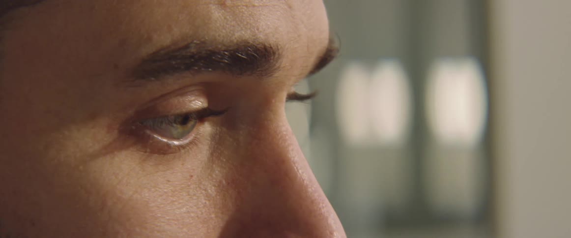 Close up of a mans eyes as he talks