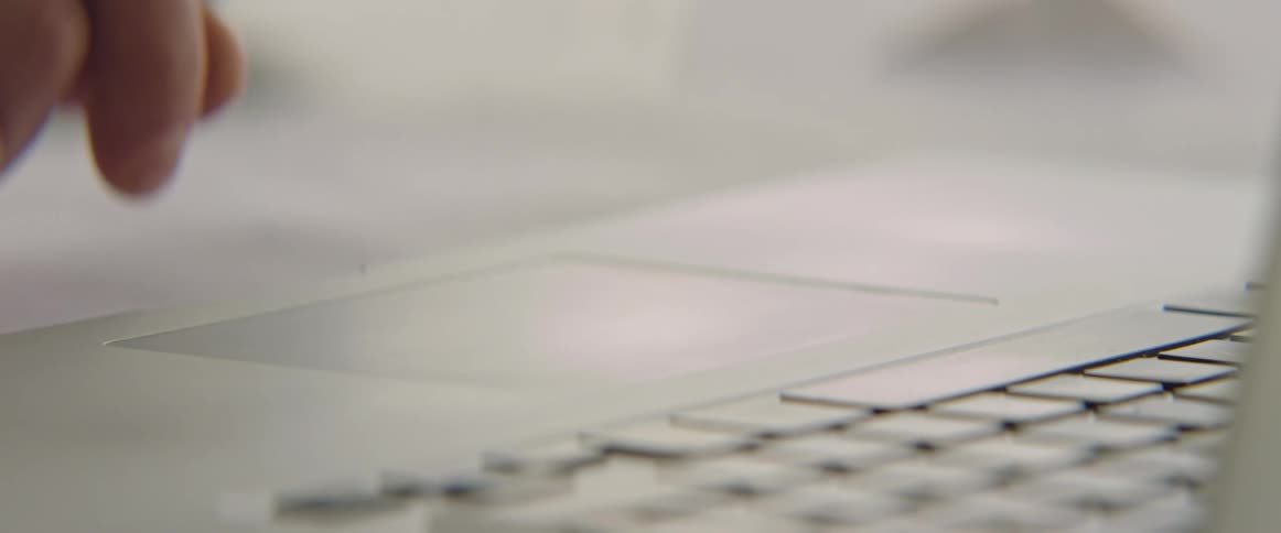 Hand and finger using a laptop computer