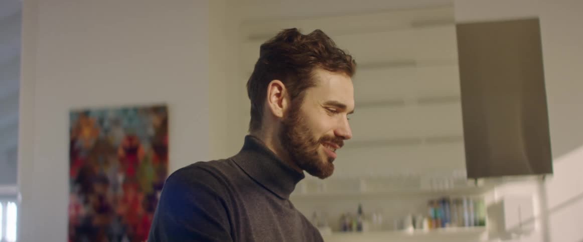 Bearded young man working at the office talking on a video conference