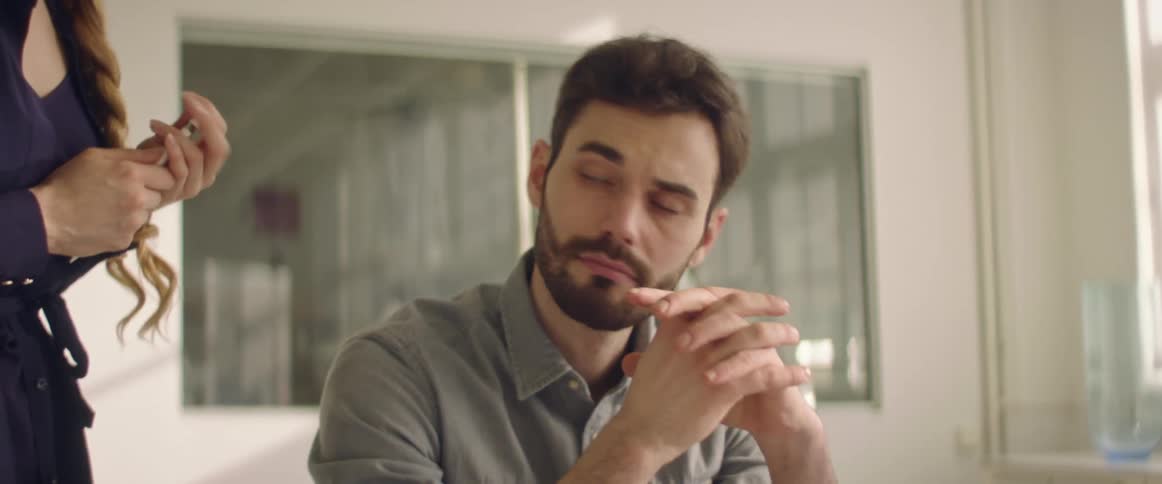 Employee working on a laptop listening to the instructions from his boss
