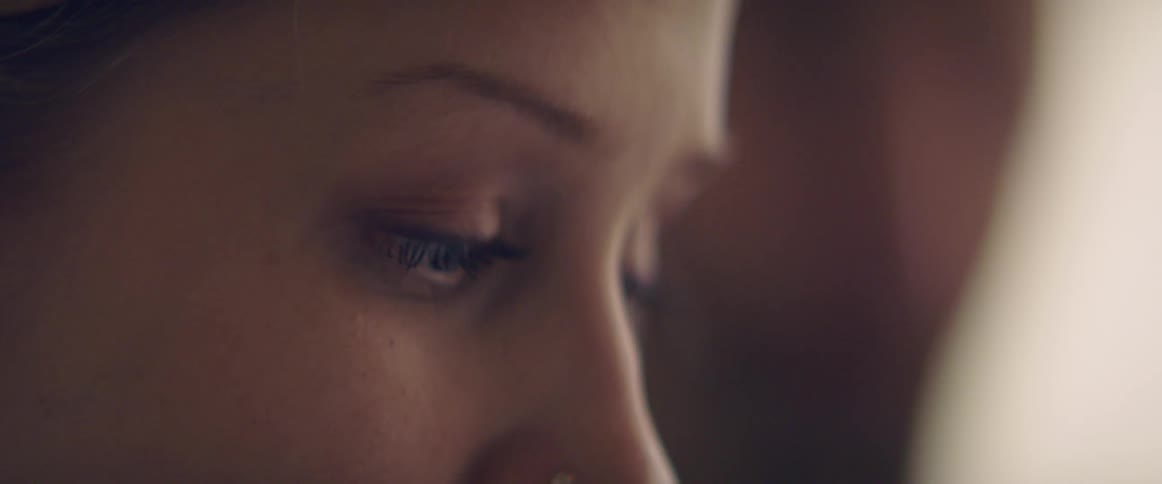 A profile of a woman with a nose piercing