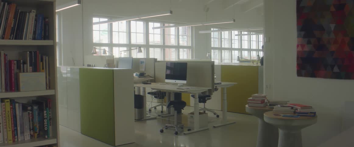 Bearded young man working at the office stands up and leaves