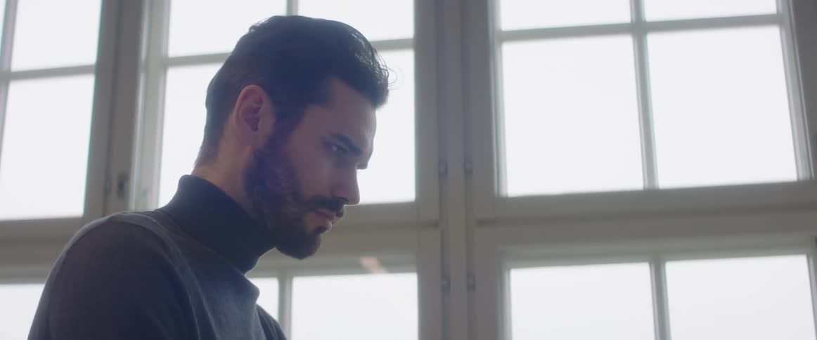 A man in an office looks down as he works