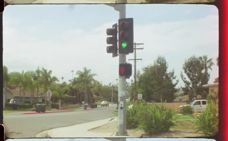 Traffic lights changing from green to yellow at a crosswalk