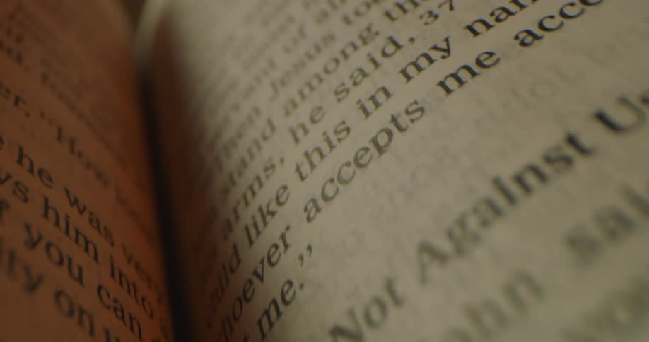 A bible in a room with a wall in the background