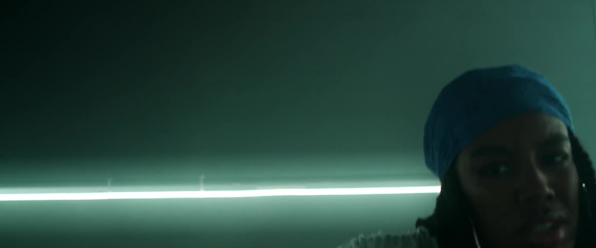 Young woman wearing a headband dancing inside a dimly lit room