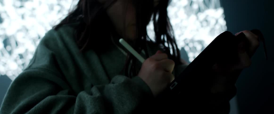 A woman writing on a tablet