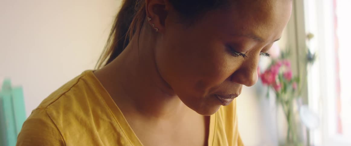 Close up of a woman working in a room at home