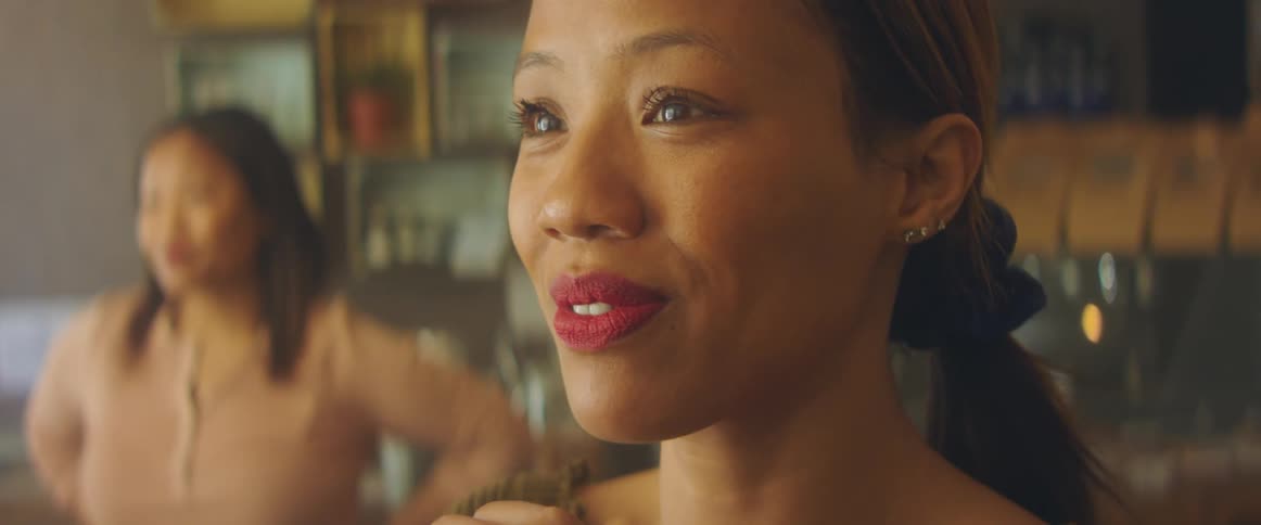 A woman standing around in a room talking