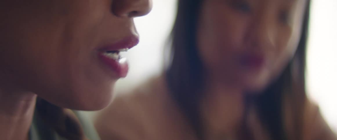 Two women talk together by the window