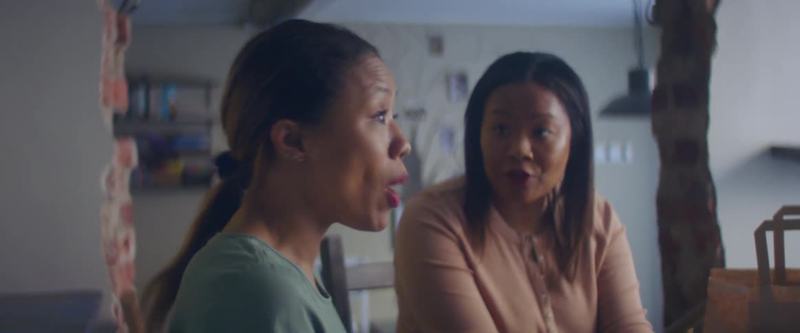 Two friends are talking to each other indoors