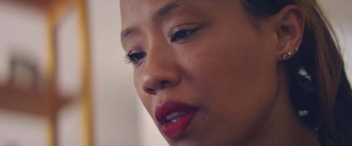 A woman is standing in a room indoors