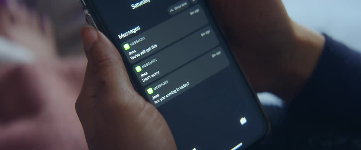 A person is looking at their cell phone indoors