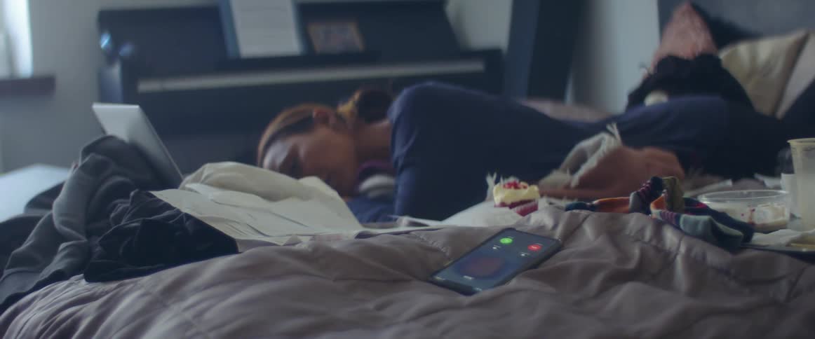 A woman rests as she is trying to read something