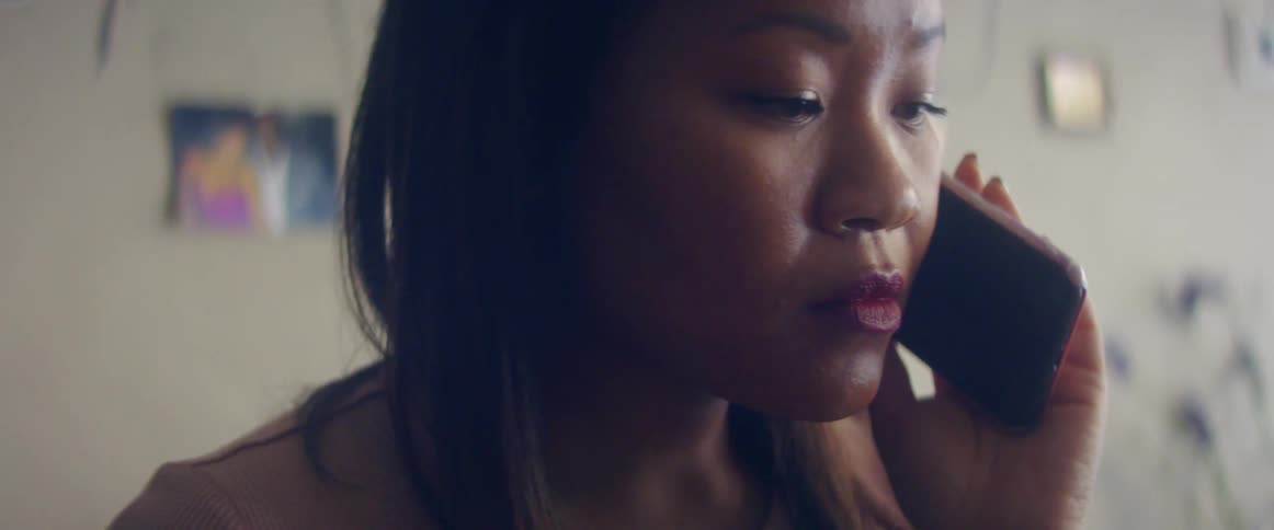 A woman looking sad while talking on the phone