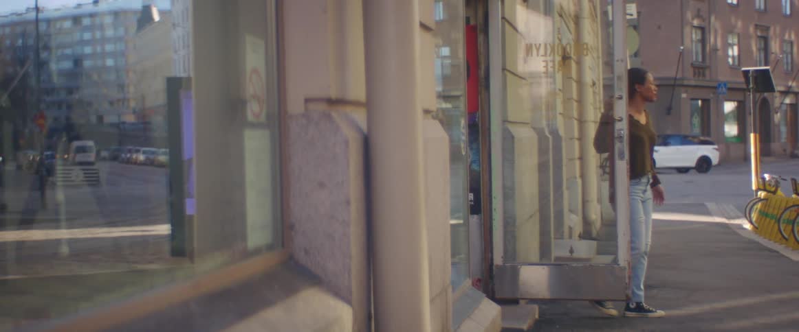 Owner of a store in the city downtown opens the door at morning