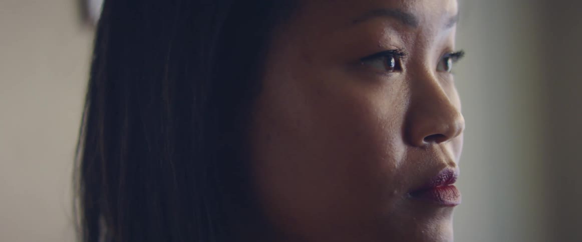 A young asian woman looking in to the distance