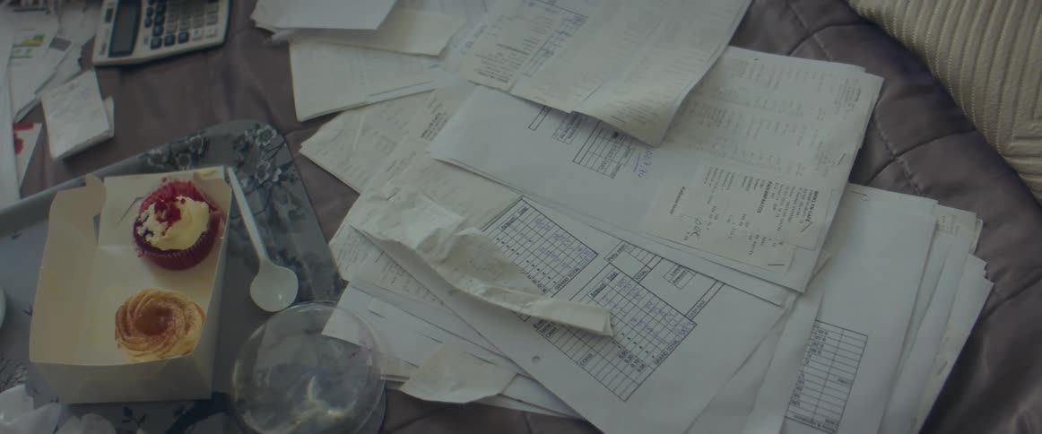 Receipts and desserts over the blanket of a bed at home