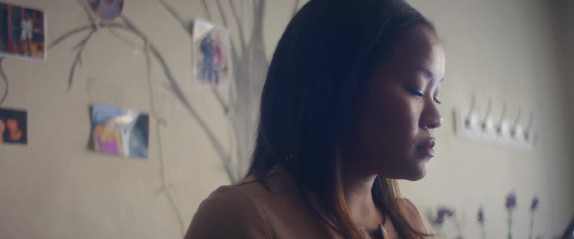 A woman is talking on the phone indoors