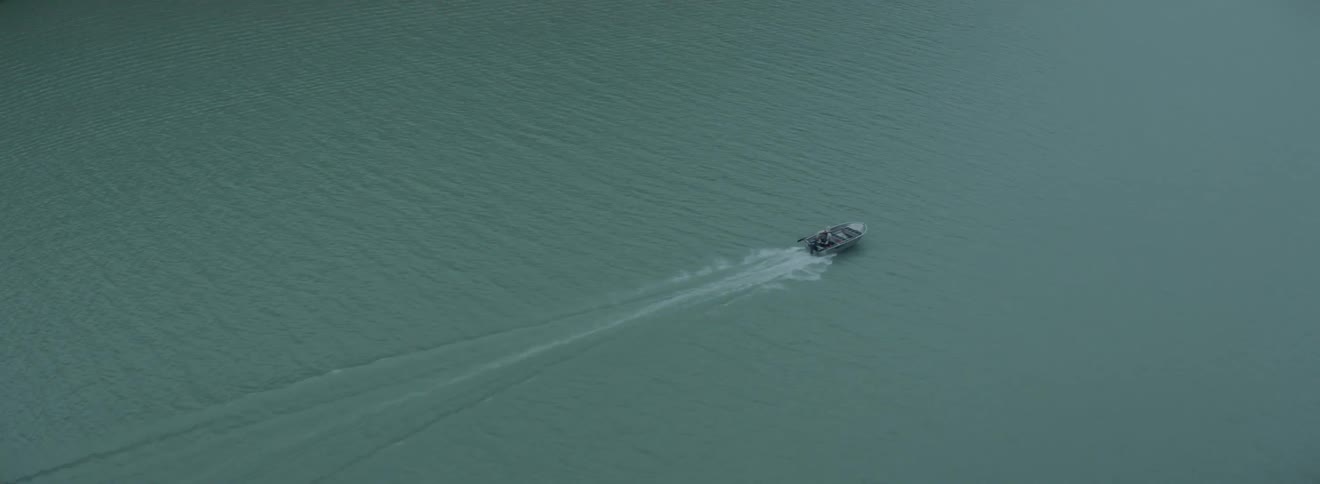 A boat is racing in the water below