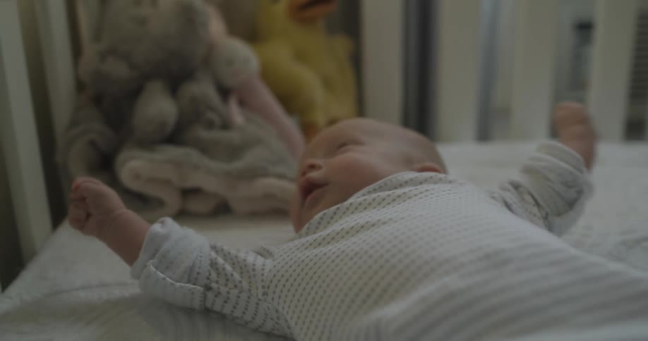 A baby laying in a crib after a nap