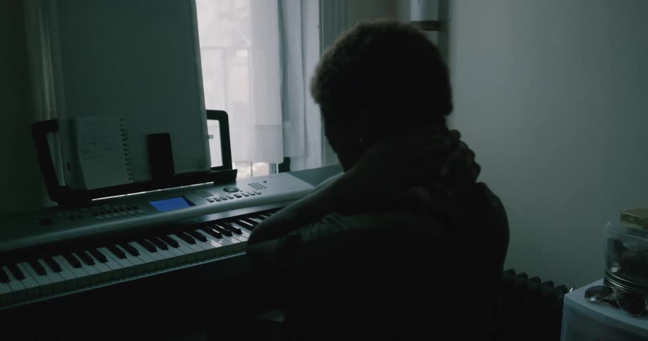 A woman takes a break from playing the piano