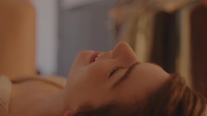 Happy woman smiles while laying on the floor of the livingroom