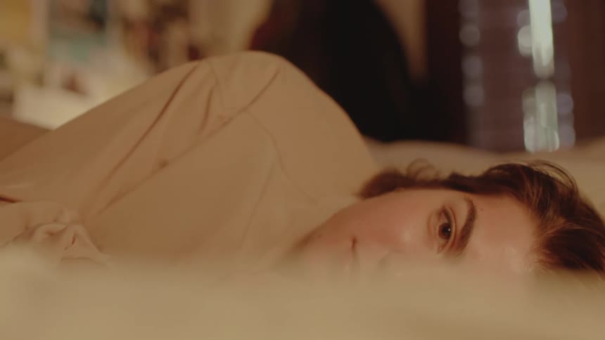 A woman is resting in bed