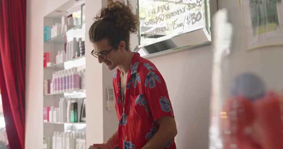 A man washing a womans hair at a salon