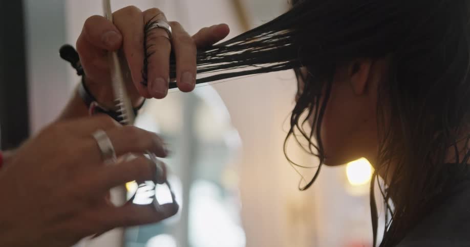 A man cutting a womans hair