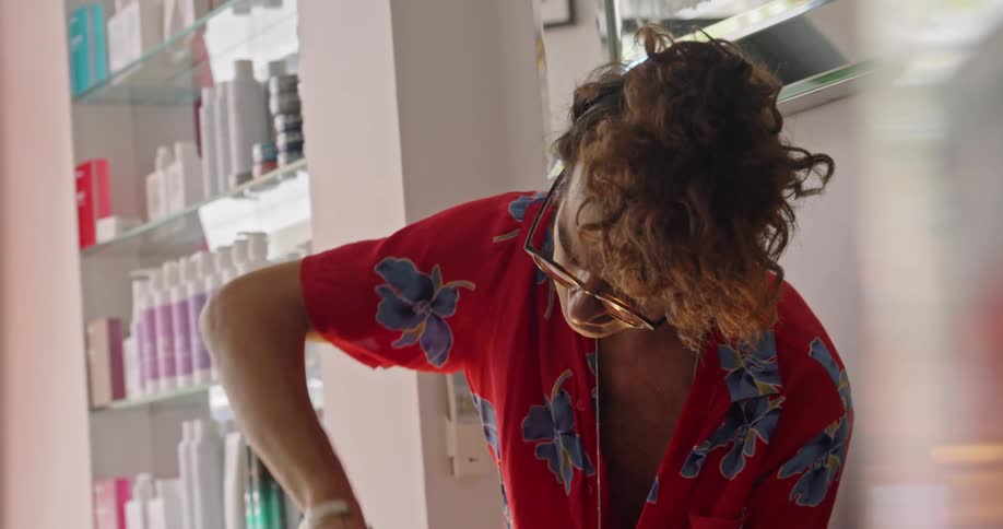 Hair stylist combing the wet hair of a client in the salon