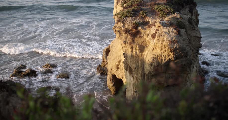 Small waves coming ashore on a rocky beach