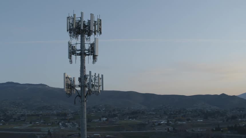Sunrise traverse past multiple cellular data antennas mounted to a monopole mast
