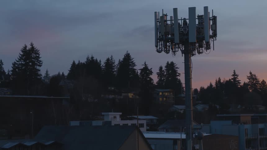 Counter clockwise orbit around a neighborhood cell tower at dawn