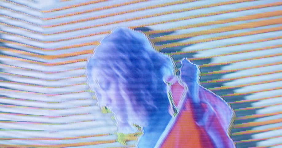 A woman is shown on a digital display