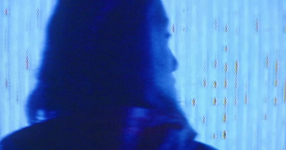 A musician in a room with screens