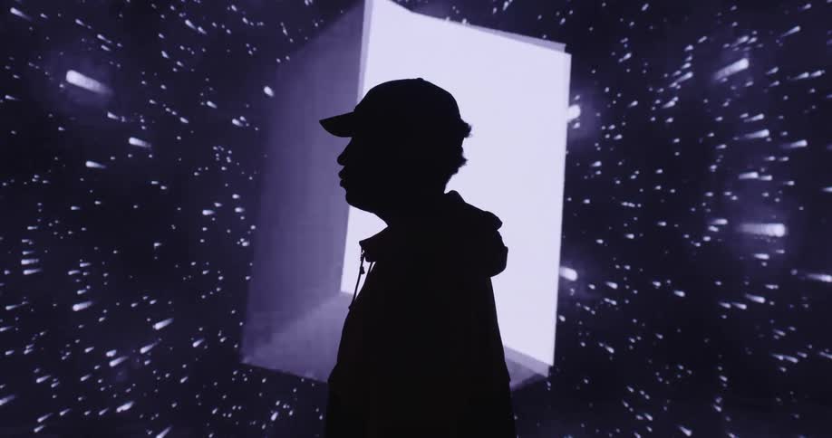 A man is posing in front of a digital image