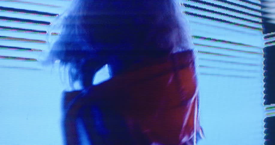 A woman spinning and dancing in front of a digital screen